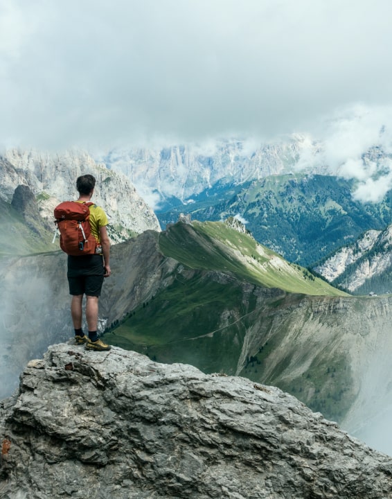 Hiker standing at the top of a mountainous overlook
